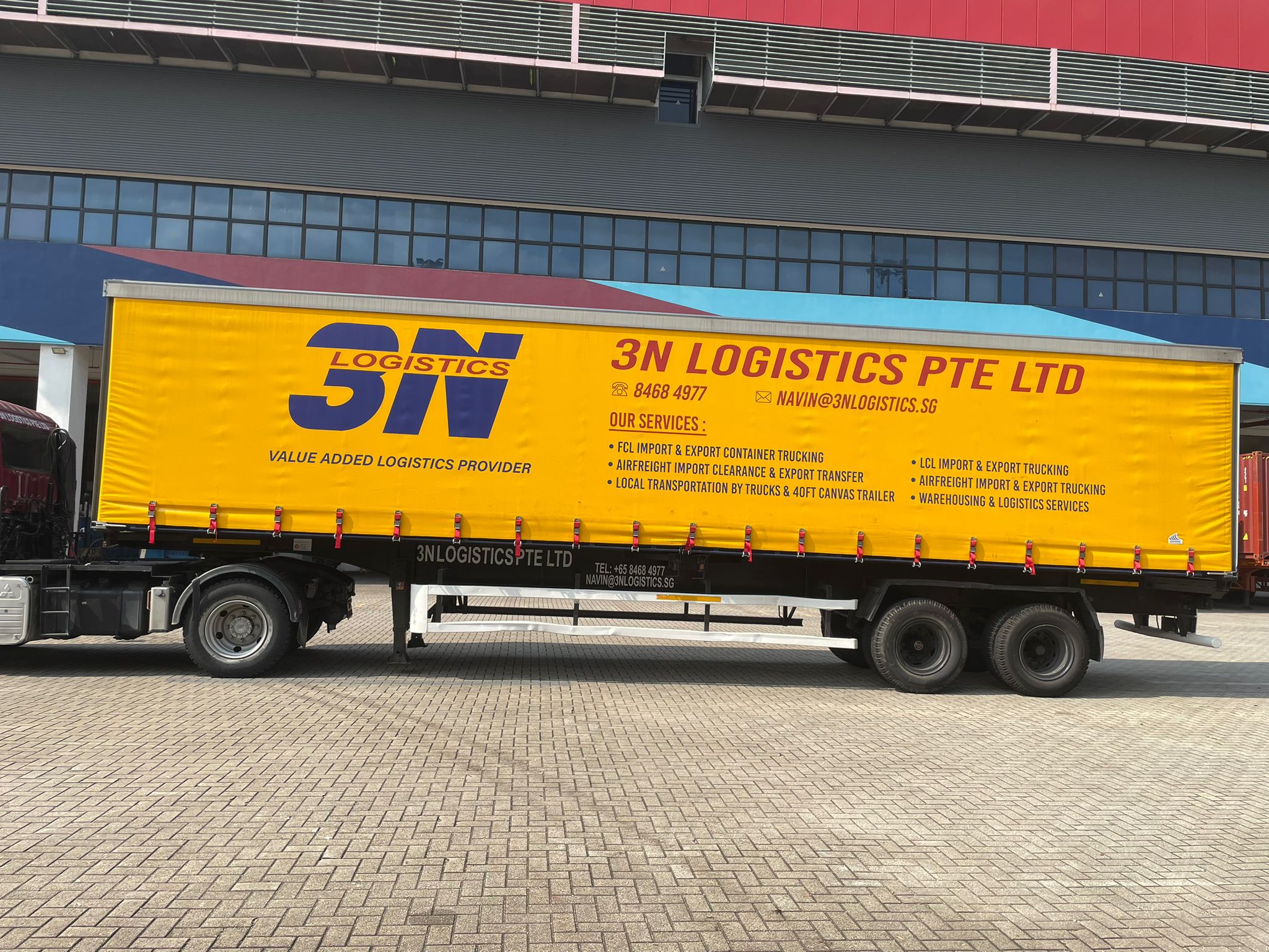 3N Logistics branded canvas trailer at warehouse