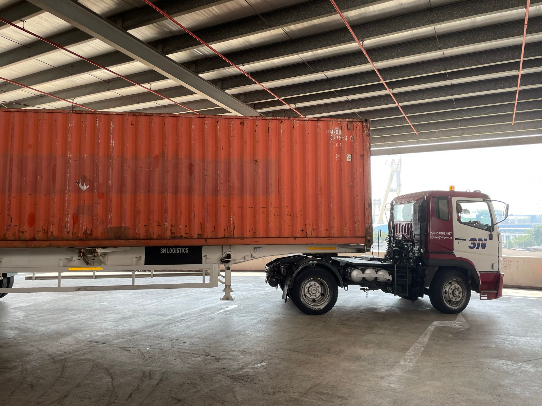 3N Logistics truck at port with container cranes in background